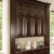 The design of this cabinet merges into the surrounding columns and cornice.